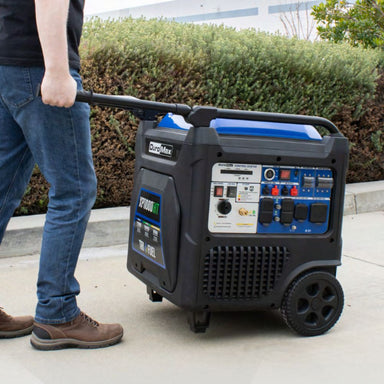 Duromax XP11000iHT Tri-Fuel Inverter Generator being pushed by a man wearing jeans